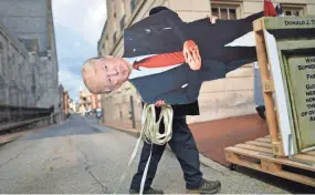  ?? MARK MAKELA/GETTY IMAGES ?? A Donald Trump effigy is wheeled to a protest in Harrisburg, Pa., on Sunday. Facebook says it is watching for “signals of violence.”