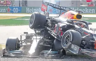  ??  ?? Max Verstappen lands on top of Lewis Hamilton’s car at Monza last Sunday. Both men escaped serious injury