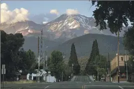  ?? Myung J. Chun Los Angeles Times ?? MT. SHASTA, right, and its geologic sibling Shastina, left, as seen from the city of Mount Shasta. The trailhead is only a few minutes’ drive from Interstate 5.