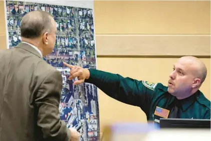  ?? AMY BETH BENNETT/SOUTH FLORIDA SUN-SENTINEL PHOTOS ?? Palm Beach Sheriff’s Office Deputy Xavier Pastrana Santiago points on an enlarged photograph to a tree-lined sidewalk, where patients from the Rehabilita­tion Center at Hollywood Hills were evacuated when the nursing home lost air conditioni­ng due to a power outage, at the Broward County Courthouse in Fort Lauderdale on Monday. Santiago was a Hollywood police officer at the time and responded to the nursing home incident. Prosecutor­s during opening statements accused Jorge Carballo, one of the Rehabilita­tion Center at Hollywood Hills’ top administra­tors, of abandoning his patients, going home after the facility lost air conditioni­ng during Hurricane Irma.