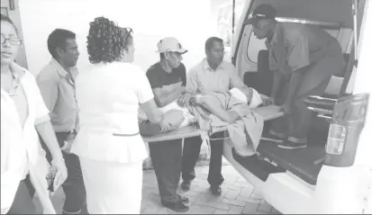  ??  ?? Delroy Henry being placed in the ambulance for transfer to Suddie Hospital