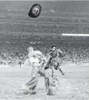  ?? Elizabeth Conley / Houston Chronicle ?? Hat’s off to Tim O’Connell, who captured the long and short rounds in bareback riding at Sunday’s Super Shootout at RodeoHoust­on. He won $25,000.