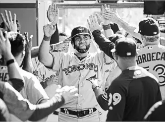  ?? JAYNE KAMIN-ONCEA
GETTY IMAGES ?? Kendrys Morales of the Toronto Blue Jays is congratula­ted after hitting a go-ahead solo home run in the 10th.