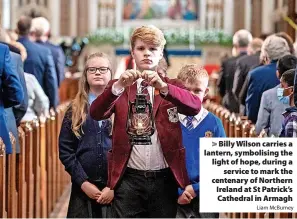  ?? Liam McBurney ?? Billy Wilson carries a lantern, symbolisin­g the light of hope, during a service to mark the centenary of Northern Ireland at St Patrick’s Cathedral in Armagh