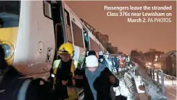  ?? PA PHOTOS. ?? Passengers leave the stranded Class 376s near Lewisham on March 2.