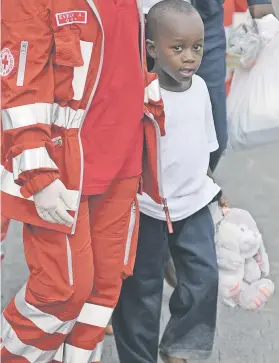  ?? Picture: AFP ?? MADE IT. A Red Cross worker helps a migrant minor disembark from the Italian Coast Guard vessel, yesterday.