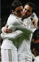  ??  ?? Real mates: Gonzalo Higuain (right) is hugged by Mesut Ozil after scoring the third goal against Granada. — Reuters