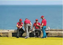  ?? Jon Super / Associated Press ?? Marshalls apply sunscreen during a practice round at Royal Portrush. The 148th Open Championsh­ip begins Thursday.