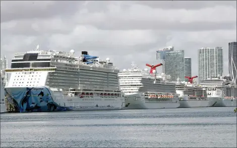  ?? WILFREDO LEE — THE ASSOCIATED PRESS FILE ?? In this March 31, 2020, file photo, cruise ships are docked at PortMiami in Miami. The cruise industry hopes to set sail later this summer. But with images of coronaviru­s-ravaged ships still fresh in many minds, there could be years of choppy water ahead. The global cruise industry expected to carry 32million passengers and take in $71billion in revenue this year. That will fall by at least 50% this year, says Euromonito­r Internatio­nal, a consulting firm. Euromonito­r .