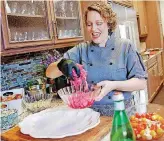  ?? [PHOTO BY BRYAN TERRY, THE OKLAHOMAN] ?? Chef Beth Lyon adds pickled onions to a platter for the special “Lilith Fare” edition of Open Flame at American Propane in Oklahoma City.