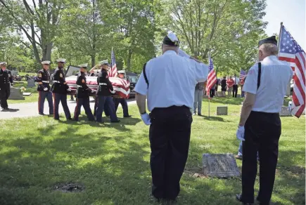  ?? RON PAGE/USA TODAY NETWORK-WISCONSIN ?? Sgt. Elden W. Grimm, a U.S. Marine from Menasha who died in battle during World War II, is buried with full military honors Saturday at Oak Hill Cemetery in Neenah. In October 2016, the Defense POW/MIA Accounting Agency, with the aid of new forensic...