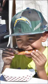  ?? PHOTO TOM BODUS ?? Brawley resident Justin Flynn, 6, devours a rib at the Brawley elk Lodge’s third annual Rib Cook-off on saturday.