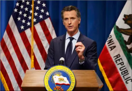  ?? AP Photo/Rich Pedroncell­i ?? In this May 14 file photo California Gov. Gavin Newsom discusses his revised 2020-2021 state budget during a news conference in Sacramento, Calif.
