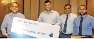  ?? ?? Winner of the raffle draw, Baduru Zaman, Director of Asialink (Pvt.) Ltd., receiving his prize