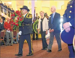  ??  ?? John Haslam and his wife, Diane Haslam, are escorted by Scott Krueger, commander of the Milwaukee County sheriff’s honor guard. Haslam is the nephew of Earl R. Haslam, a Milwaukee County sheriff’s deputy who was killed in an on-duty crash in 1929.