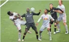  ?? ADAM CAIRNS/COLUMBUS DISPATCH ?? Crew forward Gyasi Zardes fights for a header with Red Bulls midfielder Dru Yearwood, left, and defender Kyle Duncan.