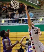  ?? PILOT PHOTO/BEV HARAMIA ?? Glenn’s Joe Delinski (12) goes up for a layup against SB Clay earlier this season. If things go right Friday night during sectional play, the Falcons will play another Northern Indiana Conference foe in the finals Saturday.