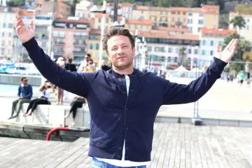  ?? — AFP photo ?? British chef and activist Jamie Oliver, poses during a photocall for a TV series ‘Jamie Oliver’ as part of the MIPCOM, the world’s biggest television and entertainm­ent market, on Monday in Cannes, southeaste­rn France.