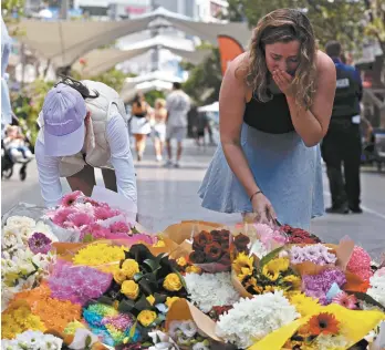  ?? ?? Members of the public leave floral tributes at Westfield Bondi Junction on Sunday. David Gray / AFP