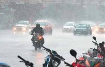  ?? — R. PAVAN ?? Vehiclists make their way gingerly through heavy rain at Greelands in the city on Saturday.