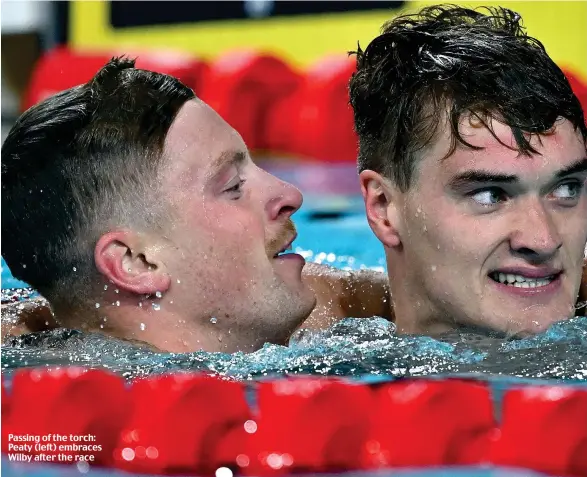  ?? ?? Passing of the torch: Peaty (left) embraces Wilby after the race