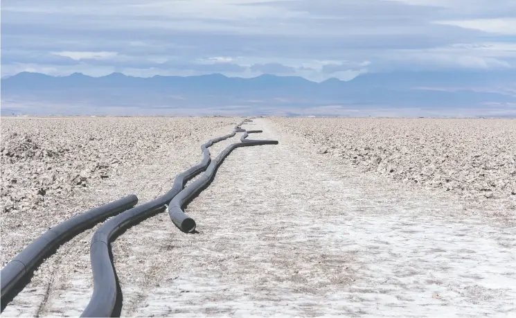  ?? Cristobal Olivares / Bloomb erg ?? Lengths of black plastic pipe lie on the ground at a lithium mine in the Atacama Desert in Chile.