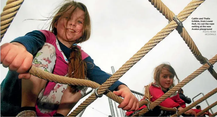  ?? PHOTO: PETER MCDONALD ?? Caitlin and Thalia Gribble, from Lower Hutt, try out the rope netting at the new Avalon playground