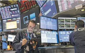  ?? CRAIG RUTTLE/AP ?? Trader Gregory Rowe works on the floor of the New York Stock Exchange at the end of the trading day on Monday.