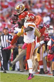  ?? Scott Strazzante / The Chronicle ?? The 49ers' Brandon Lloyd makes a fourth-quarter reception in front of the Chiefs’ Sean Smith.