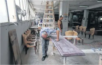  ?? AZIZ TAHER • REUTERS ?? Men work inside Sleep Comfort furniture factory that was damaged during the Beirut port blast Aug. 13. The business lost one-third of its furniture and expect losses are around $600,000.