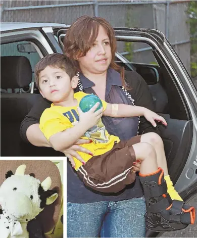  ?? STAFF PHOTO BY STUART CAHILL ?? NO BULL: Two-year-old Eduardo Gomez arrives home with his mother, above, after falling from a second story window in Chelsea yesterday, only to land on his stuffed cow, ‘Vaca,’ left. Gomez suffered only cuts and bruises.