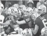  ?? RON JENKINS/AP ?? Raiders kicker Daniel Carlson (2) is congratula­ted by teammates after his game-winning field goal against the Cowboys in OT Thursday in Arlington, Texas.