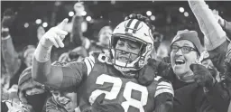  ?? AARON GASH/AP ?? Packers running back AJ Dillon celebrates with fans after rushing for a touchdown against the Seahawks on Sunday in Green Bay, Wis.