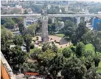  ??  ?? Metro Rail passes from behind the Clock Tower