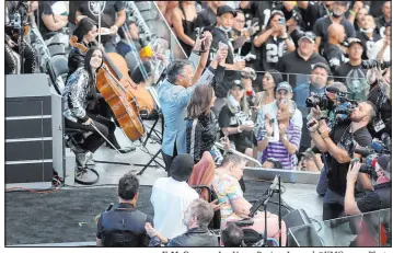  ?? K.M. Cannon Las Vegas Review-journal @Kmcannonph­oto ?? Former Nevada Gov. Brian Sandoval, center, lights the Al Davis Memorial Torch before Monday night’s Raiders game at Allegiant Stadium.