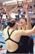  ?? ?? New Albany's Olivia Hovorka, right, and Carly Meeting celebrate after winning the 400-yard freestyle relay at the Division I state meet last season.