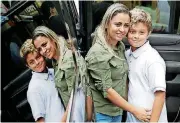 ?? [AP PHOTO] ?? Sirley Silveira Paixao, center, an immigrant from Brazil seeking asylum, poses for a photo with her 10-year-old son Diego Magalhaes, after Diego was released from immigratio­n detention shortly before they depart for a flight to Boston Thursday in...