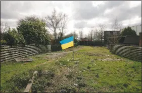  ?? DMITRY KOSTYUKOV / THE NEW YORK TIMES ?? A Ukrainian flag is planted on land that belongs to Jorrit Faassen, the former husband of Maria Vladimirov­na Vorontsova, as Vladimir Putin’s oldest daughter is known, near Amsterdam. As Western nations place sanctions on people close to the Russian leader, including family members, the strict secrecy surroundin­g his private life is being punctured.