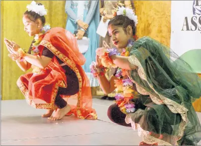  ?? MITCH MACDONALD/THE GUARDIAN ?? Cousins Urmila Khanal, right, and Gita Khanal perform a dance while wearing traditiona­l Indian dresses during the Diwali dinner hosted by the IndoCanadi­an Associatio­n of P.E.I. at Cornwall’s APM Centre on Sunday. Proceeds from the event went towards...