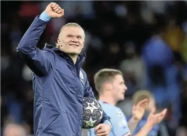  ?? /Reuters ?? Having a ball: Manchester City's Erling Braut Haaland celebrates as he carries the match ball after scoring five goals in the Euro Champions League win over RB Leipzig.