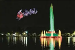  ?? COURTESY ?? Santa Claus flies over the Lake Eola fountain in Orlando.