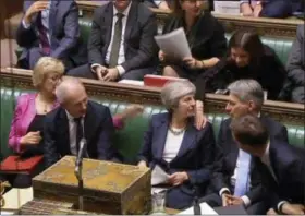  ?? PARLIAMENT TV — PA VIA AP ?? Britain’s Prime Minister Theresa May Prime Minister Theresa May is congratula­ted by Conservati­ve Party ministers in the House of Commons after speaking at the start of a five-day debate on the Brexit European Union Withdrawal Agreement, Tuesday. The British government received a historic rebuke from lawmakers on Tuesday over its Brexit plans, an inauspicio­us sign for Prime Minister Theresa May as she opened an epic debate in Parliament that will decide the fate of her Brexit divorce deal with the European Union.