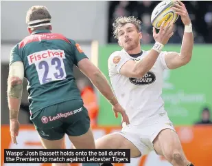  ??  ?? Wasps’ Josh Bassett holds onto the ball during the Premiershi­p match against Leicester Tigers