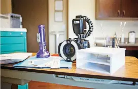  ?? [PHOTOS BY ANYA MAGNUSON, THE OKLAHOMAN] ?? Equipment used when conducting a sexual assault examinatio­n, including a camera, contrast light and swabs, sits on a table in one of the YWCA Oklahoma City’s exam rooms.