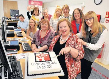  ??  ?? Milestone Pam Wilson, left, and Susan Carter cut the cake at the new centre