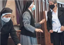  ??  ?? Rosita Beatriz Espericuet­a, right, an administra­tor at St. Matthew’s, guides nuns during an Ash Wednesday Mass.