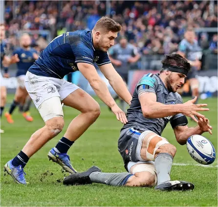  ?? PICTURE: Dan Mullan/getty Images ?? Bath Rugby’s Josh Bayliss dives on the loose ball under pressure from Jordan Larmour during the record-breaking Heineken Cup defeat against Leinster