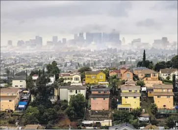  ?? Kent Nishimura Los Angeles Times ?? LOW-HANGING CLOUDS fringe the downtown L.A. skyline Wednesday. The weather system was fed by a moisture-rich atmospheri­c river — a type of storm that scientists say has grown more intense in recent years.