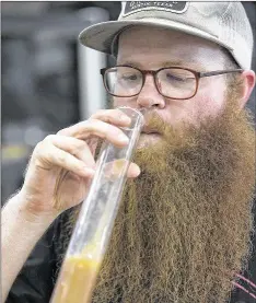  ?? RALPH BARRERA / AMERICANST­ATESMAN ?? Brewery worker Jacob Piland tastes a brew of Van Dayum! as it nears finish in the brewery.