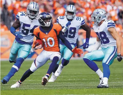  ?? JACK DEMPSEY/ASSOCIATED PRESS ?? Broncos wide receiver Emmanuel Sanders (10) tries to elude Cowboys safety Jeff Heath (38), linebacker Jaylon Smith (54) and defensive end Charles Tapper during Sunday’s game in Denver. The Broncos rolled 42-17.